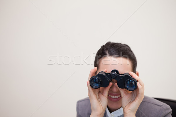 Young businesswoman looking through binoculars Stock photo © wavebreak_media