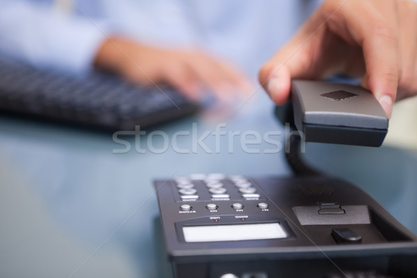Telephone conversation being ended by young businessman Stock photo © wavebreak_media