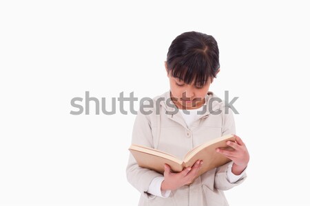 Girl reading a book against a white background Stock photo © wavebreak_media
