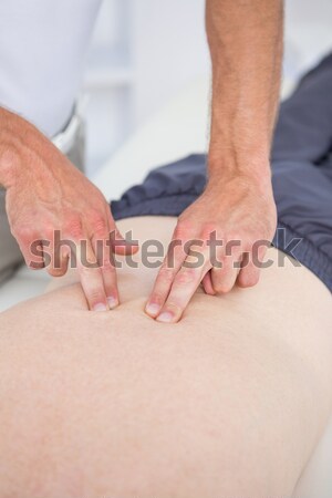 Osteopath massaging a woman in the middle of her back in a room Stock photo © wavebreak_media