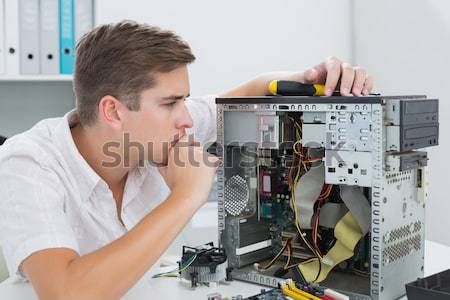 Computer engineer working on cpu while on call Stock photo © wavebreak_media