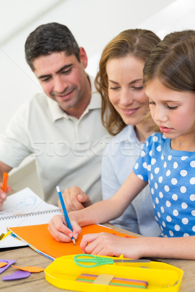 Parents looking at girl coloring Stock photo © wavebreak_media