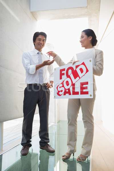 Estate agent giving keys to new home owner Stock photo © wavebreak_media