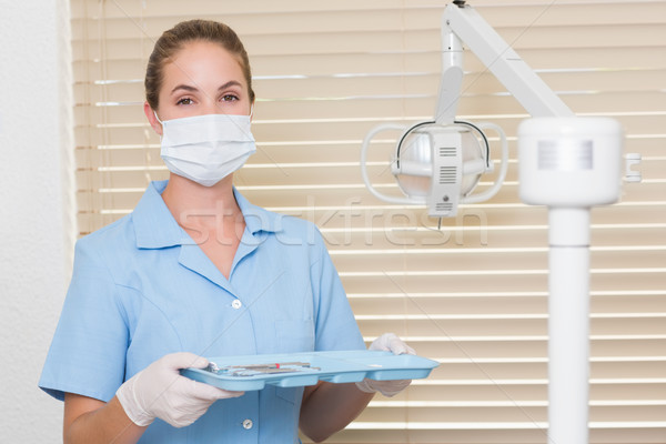 Dental assistant in blue holding tray of tools Stock photo © wavebreak_media