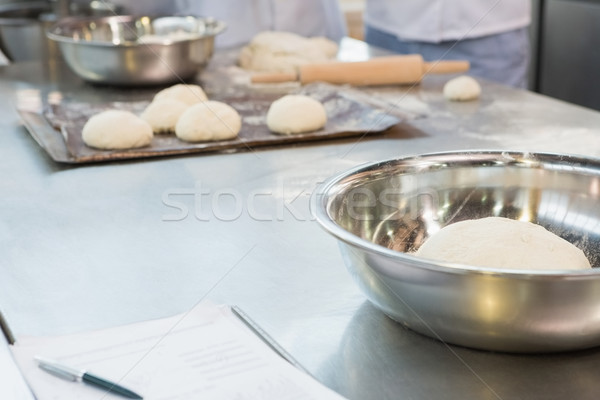 Stock photo: Close up of bowl with dough on worktop