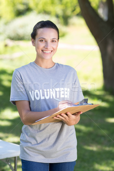 Boldog önkéntes park napos idő nő dolgozik Stock fotó © wavebreak_media
