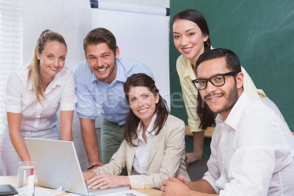 Casual business team having a meeting using laptop Stock photo © wavebreak_media