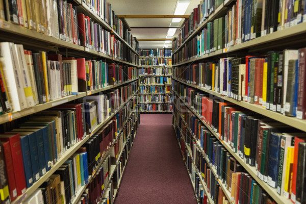 Volumes of books on bookshelf in library Stock photo © wavebreak_media