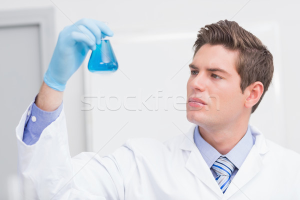 Scientist looking attentively at the beaker Stock photo © wavebreak_media