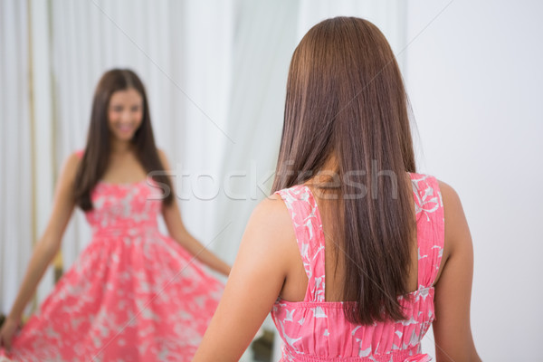 Smiling woman trying on a dress Stock photo © wavebreak_media