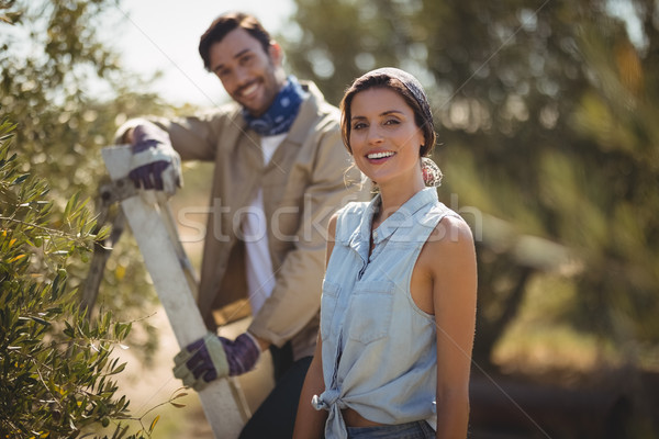 Happy young couple standing by trees at olive farm Stock photo © wavebreak_media