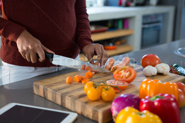 木 / mid section of woman cutting vegetables at kitchen countr