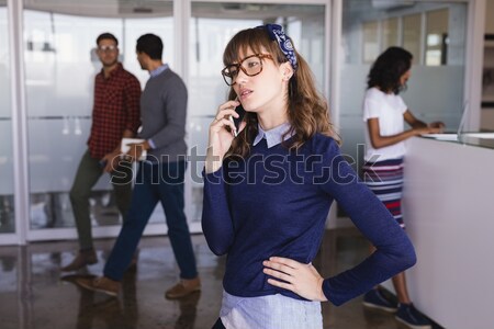 Worried woman with head in hand while friends discussing in background Stock photo © wavebreak_media