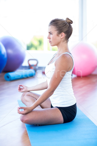 Vue de côté femme méditation fitness studio sport [[stock_photo]] © wavebreak_media