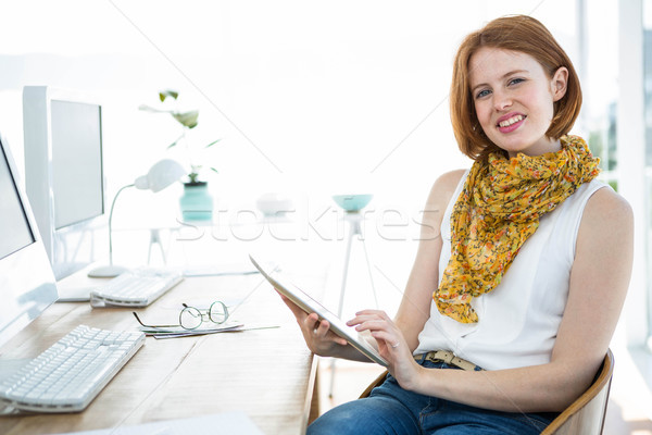 smiling hipster woman on a tablet Stock photo © wavebreak_media