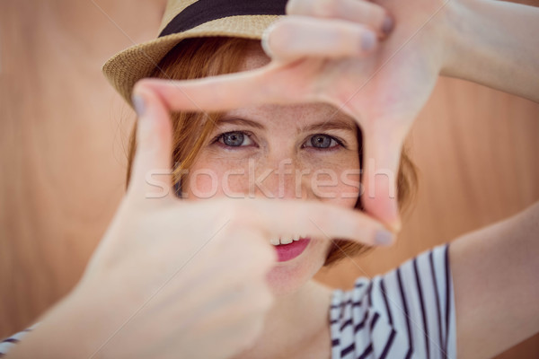 Blue eyed hipster looking through her hands Stock photo © wavebreak_media