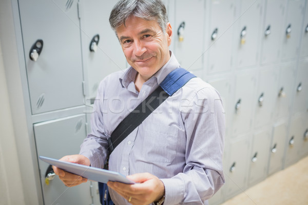 Portrait of professor using digital tablet in locker room Stock photo © wavebreak_media