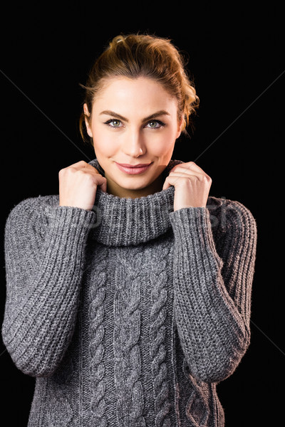 Portrait of beautiful woman posing against black background Stock photo © wavebreak_media