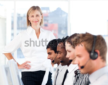 Stock photo: Happy female leader with her team on a call center