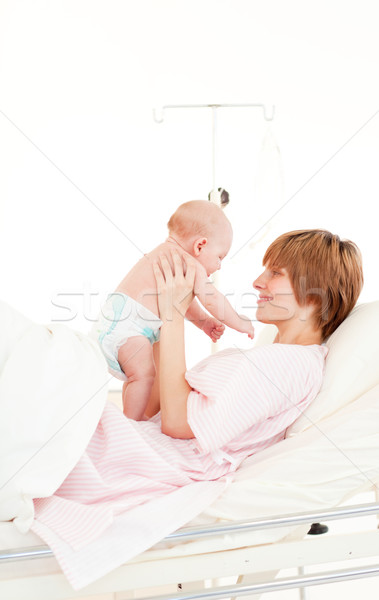 Stock photo: Mother playing with her baby son