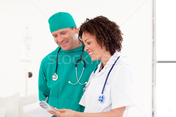 Delighted people working in a hospital holding a clip board Stock photo © wavebreak_media