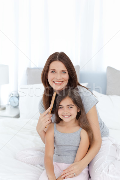 Woman brushing her daughter hair at home Stock photo © wavebreak_media