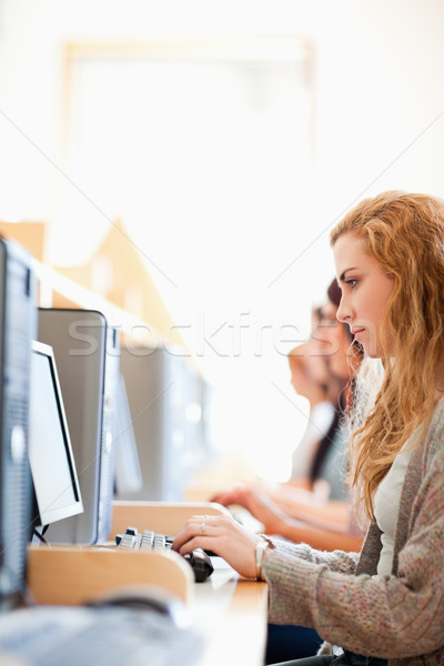 Stock photo: Portrait of a student working with a computer in an IT room