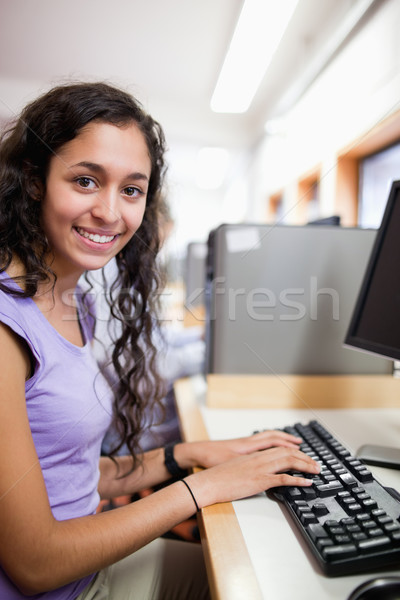 Portrait of a cute smiling student with a computer in an IT room Stock photo © wavebreak_media