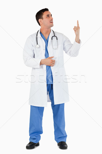 Portrait of a young doctor pointing at a copy space against a white background Stock photo © wavebreak_media
