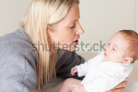 Side view of young mother laying down her newborn Stock photo © wavebreak_media