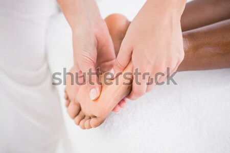 Physiotherapist using his fingers to massage a foot in a room Stock photo © wavebreak_media