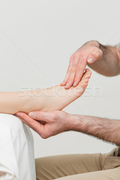 Practitioner holding the foot of a patient in a room Stock photo © wavebreak_media