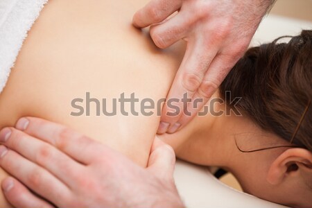 Doctor pressing the shoulder of his patient in a room Stock photo © wavebreak_media