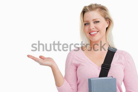 Smiling young woman raising her hand palm against a white background Stock photo © wavebreak_media