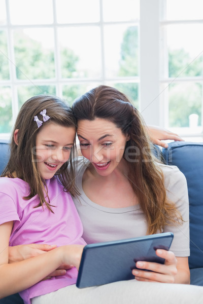 Stock photo: Mother and daughter using tablet pc