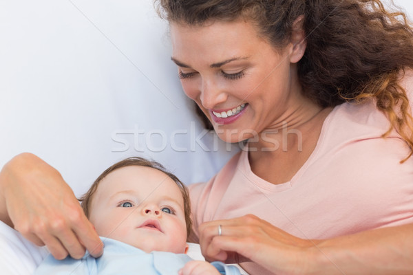 Loving mother with baby in bed Stock photo © wavebreak_media