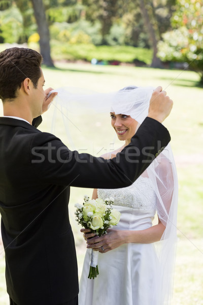 Loving groom lifting veil of bride Stock photo © wavebreak_media