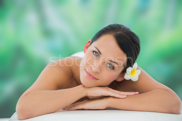 Stock photo: Beautiful brunette relaxing on massage table smiling at camera