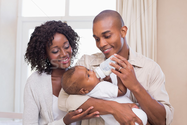 Happy parents feeding their baby boy a bottle Stock photo © wavebreak_media