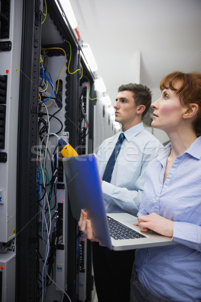 Team of technicians using digital cable analyser on servers Stock photo © wavebreak_media