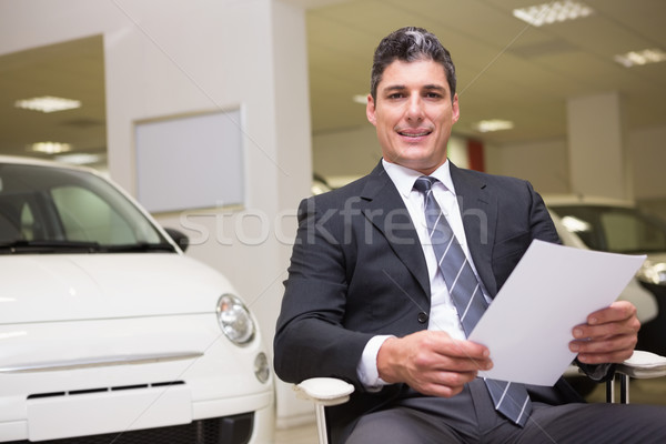 Businessman holding document at his desk Stock photo © wavebreak_media