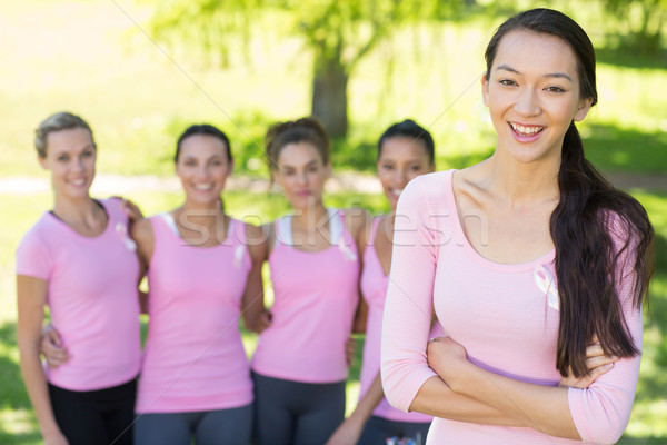 Smiling women in pink for breast cancer awareness Stock photo © wavebreak_media