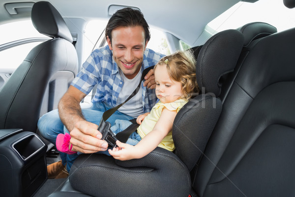 Father securing baby in the car seat Stock photo © wavebreak_media