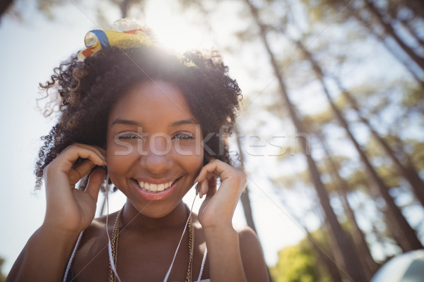 Portrait of smiling woman listening music Stock photo © wavebreak_media