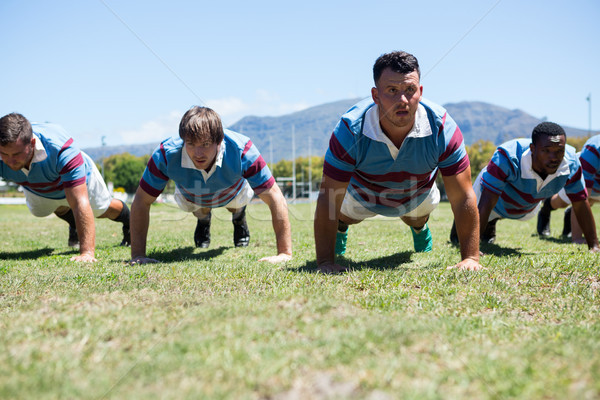 Rugby players doing push up on field Stock photo © wavebreak_media