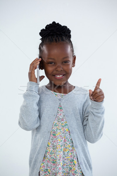 Portrait of smiling businesswoman pointing while talking on phone Stock photo © wavebreak_media