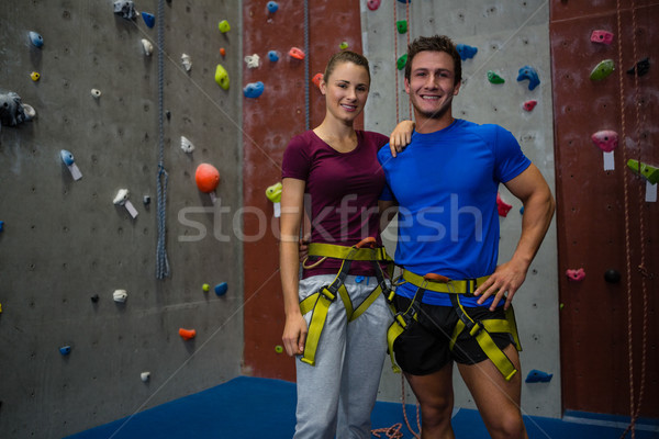 Portrait of male trainer with female athlete standing by climbing wall Stock photo © wavebreak_media