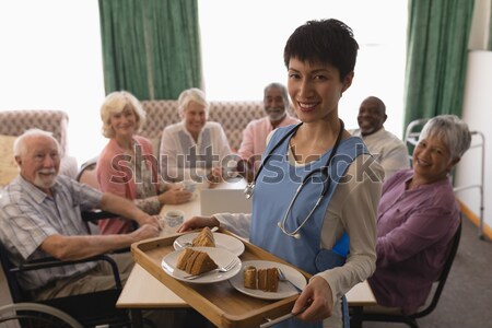 High angle view of teacher showing tablet while sitting with senior adults Stock photo © wavebreak_media