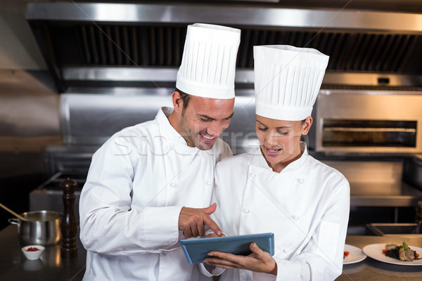 Chefs holding clipboard in kitchen Stock photo © wavebreak_media