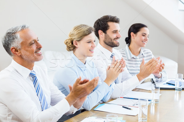 Stock photo: Business colleagues applauding in a meeting